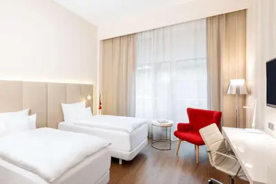 Ein Bett oder Betten in einem Zimmer der Unterkunft NH Collection Berlin Mitte Friedrichstrasse