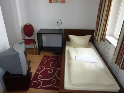 Ein Bett oder Betten in einem Zimmer der Unterkunft Hotel Pension Kima