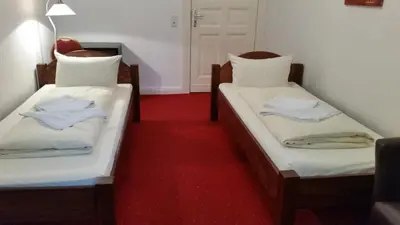 Ein Bett oder Betten in einem Zimmer der Unterkunft Hotel Pension Kima
