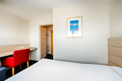 Ein Bett oder Betten in einem Zimmer der Unterkunft Enjoy Hotel am Studio
