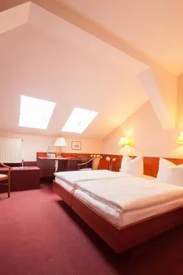 Ein Bett oder Betten in einem Zimmer der Unterkunft Hotel Kastanienhof