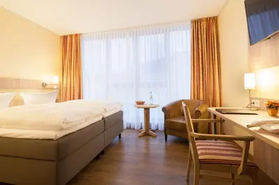 Ein Bett oder Betten in einem Zimmer der Unterkunft Hotel Kastanienhof