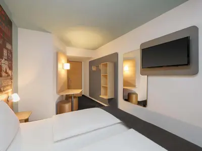 Ein Bett oder Betten in einem Zimmer der Unterkunft B&B Hotel Berlin-Dreilinden