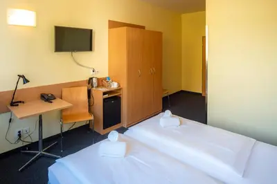 Ein Bett oder Betten in einem Zimmer der Unterkunft Familienhotel Citylight