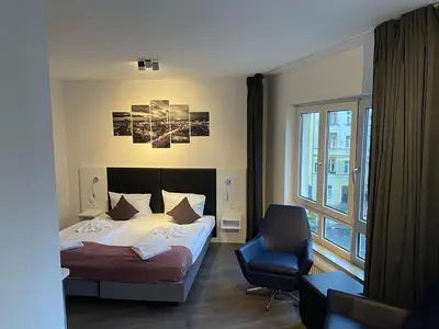 Ein Bett oder Betten in einem Zimmer der Unterkunft ALFA Hotel