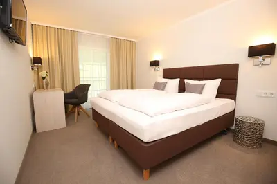 Ein Bett oder Betten in einem Zimmer der Unterkunft Landhotel Potsdam
