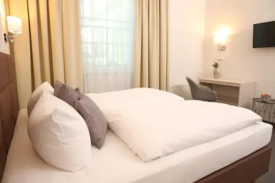 Ein Bett oder Betten in einem Zimmer der Unterkunft Landhotel Potsdam
