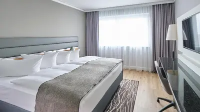 Ein Bett oder Betten in einem Zimmer der Unterkunft Holiday Inn Berlin Airport - Conference Centre by IHG