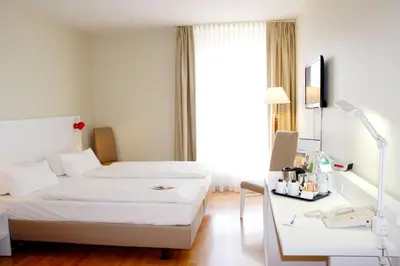 Ein Bett oder Betten in einem Zimmer der Unterkunft Hotel am Schloß Köpenick by Golden Tulip