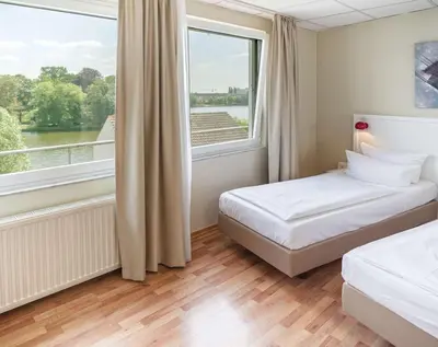 Ein Bett oder Betten in einem Zimmer der Unterkunft Hotel am Schloß Köpenick by Golden Tulip