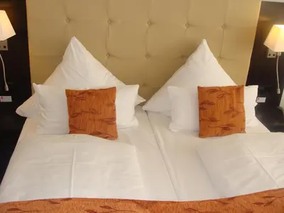 Ein Bett oder Betten in einem Zimmer der Unterkunft Aparthotel Guzulka & Restaurant
