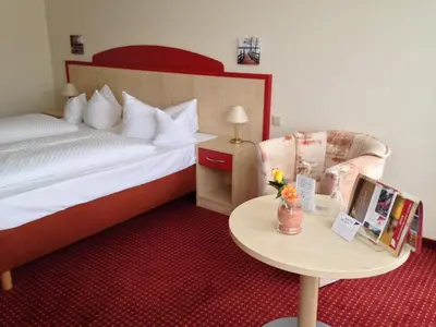 Ein Bett oder Betten in einem Zimmer der Unterkunft Morada Hotel Am Mellensee
