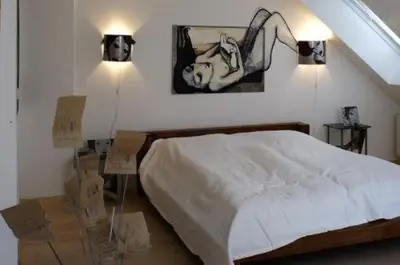 Ein Bett oder Betten in einem Zimmer der Unterkunft Arthotel Landhaus Zur Alten Gärtnerei
