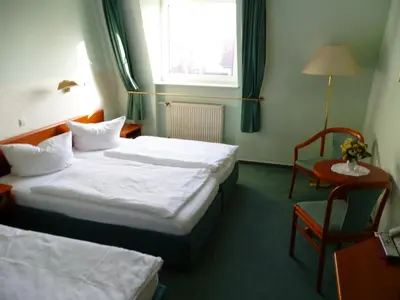 Ein Bett oder Betten in einem Zimmer der Unterkunft Hotel Brandenburg