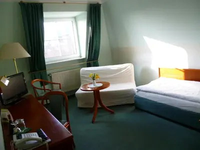 Ein Bett oder Betten in einem Zimmer der Unterkunft Hotel Brandenburg