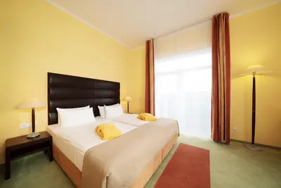 Ein Bett oder Betten in einem Zimmer der Unterkunft Resort Mark Brandenburg & Fontane Therme