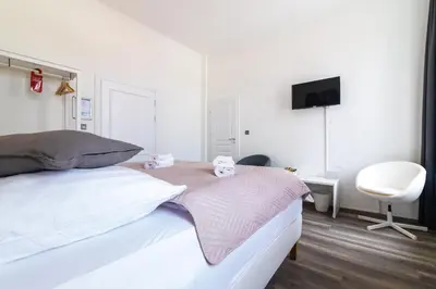 Ein Bett oder Betten in einem Zimmer der Unterkunft Hotel am Hain