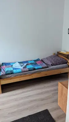 Ein Bett oder Betten in einem Zimmer der Unterkunft Pension Hubertus