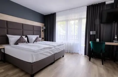 Ein Bett oder Betten in einem Zimmer der Unterkunft Waldhotel Wandlitz