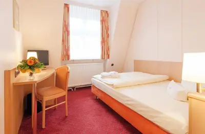 Ein Bett oder Betten in einem Zimmer der Unterkunft Hotel Benn