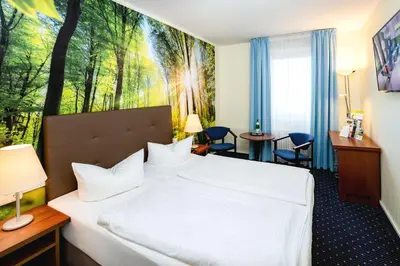 Ein Bett oder Betten in einem Zimmer der Unterkunft AHORN Seehotel Templin