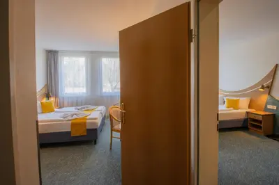 Ein Bett oder Betten in einem Zimmer der Unterkunft Seehotel Bollmannsruh