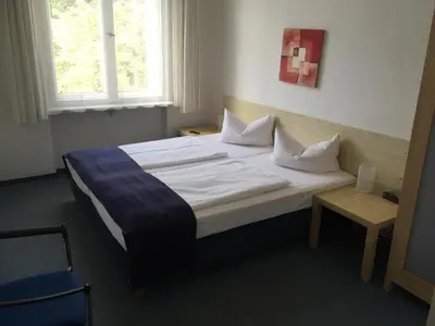 Ein Bett oder Betten in einem Zimmer der Unterkunft Hotel Seifert Berlin am Kurfürstendamm