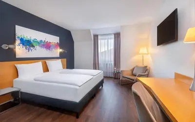 Ein Bett oder Betten in einem Zimmer der Unterkunft greet Hotel Potsdam am Park Sanssouci