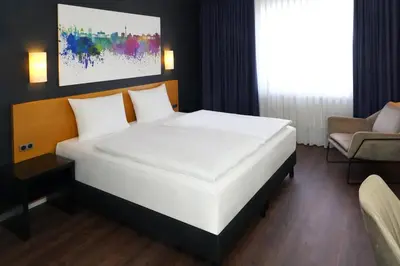 Ein Bett oder Betten in einem Zimmer der Unterkunft greet Hotel Potsdam am Park Sanssouci