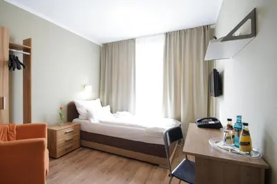 Ein Bett oder Betten in einem Zimmer der Unterkunft Hotel Pankow
