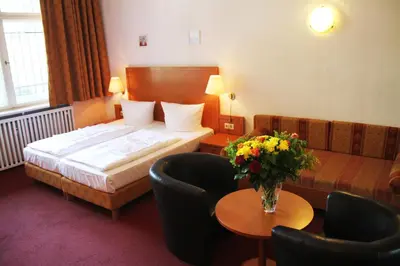 Ein Bett oder Betten in einem Zimmer der Unterkunft Hotel Aster an der Messe
