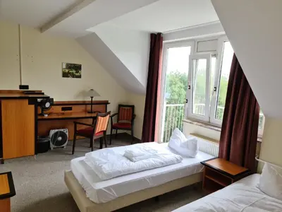 Ein Bett oder Betten in einem Zimmer der Unterkunft Landhotel Löwenbruch