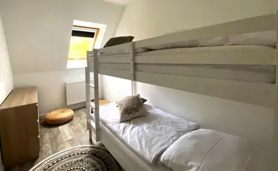 Ein Bett oder Betten in einem Zimmer der Unterkunft PRIMA Inn Ferienwohnungen Sonnenufer am Ruppiner See