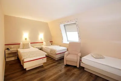 Ein Bett oder Betten in einem Zimmer der Unterkunft Hotel Märkischer Hof