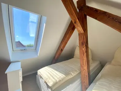 Ein Bett oder Betten in einem Zimmer der Unterkunft Über den Dächern von Eichwalde