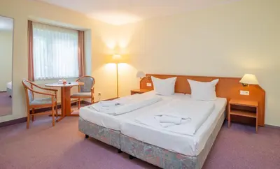 Ein Bett oder Betten in einem Zimmer der Unterkunft Waldhotel Schöneiche -Self Check-In-