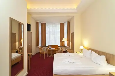 Ein Bett oder Betten in einem Zimmer der Unterkunft Hotel Vivaldi Berlin am Kurfürstendamm