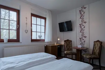 Ein Bett oder Betten in einem Zimmer der Unterkunft Hotel & Restaurant Lindengarten
