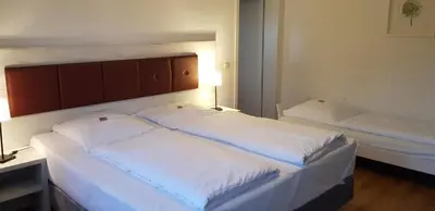 Ein Bett oder Betten in einem Zimmer der Unterkunft Hotel & Restaurant Lindengarten