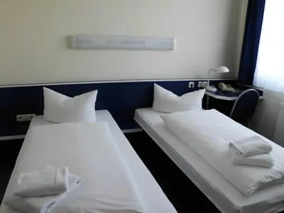 Ein Bett oder Betten in einem Zimmer der Unterkunft Central-Hotel Eberswalde