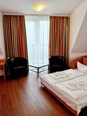 Ein Bett oder Betten in einem Zimmer der Unterkunft Hotel Kaiser