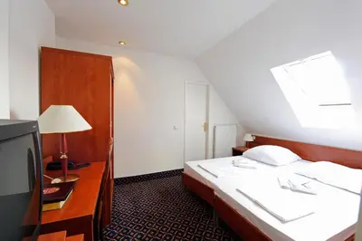 Ein Bett oder Betten in einem Zimmer der Unterkunft City Hotel am Kurfürstendamm