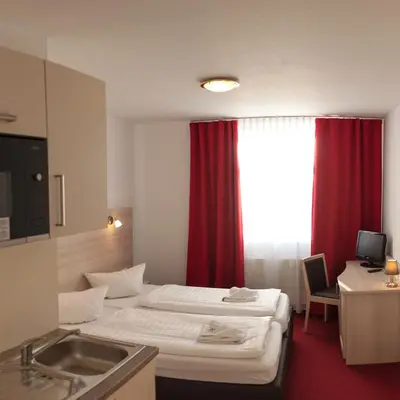 Ein Bett oder Betten in einem Zimmer der Unterkunft Apart Hotel Ferdinand Berlin