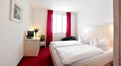 Ein Bett oder Betten in einem Zimmer der Unterkunft Apart Hotel Ferdinand Berlin