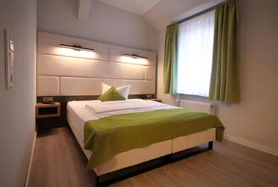 Ein Bett oder Betten in einem Zimmer der Unterkunft Hotel und Restaurant Kranichsberg