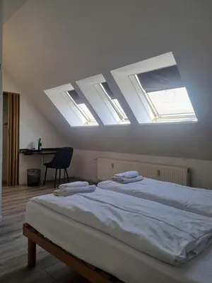 Ein Bett oder Betten in einem Zimmer der Unterkunft Erlanger Hof