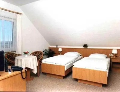 Ein Bett oder Betten in einem Zimmer der Unterkunft Hotel garni Zur Mühle