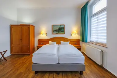 Ein Bett oder Betten in einem Zimmer der Unterkunft Hotel Fürstenhof