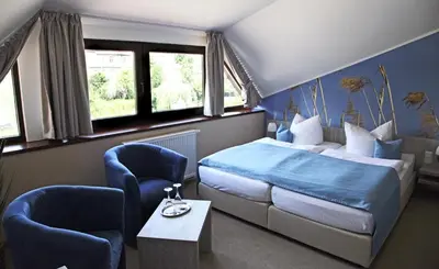 Ein Bett oder Betten in einem Zimmer der Unterkunft Zum Alten Hafen