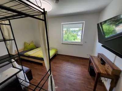 Ein Bett oder Betten in einem Zimmer der Unterkunft Ferienwohnungen Im Grund 22, 22a, 22c Birkenstein